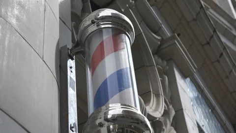 A low angle view of a barber pole. Video stock 107943613