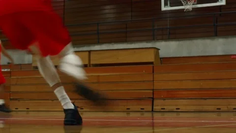 Low angle view of basketball players' legs as they jump and shoot Video stock 70681648