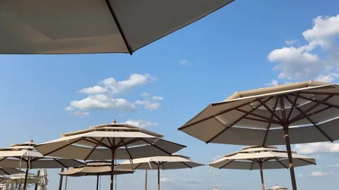 Low-angle view of beach umbrellas against blue sky, Odesa Stock Footage 339732692