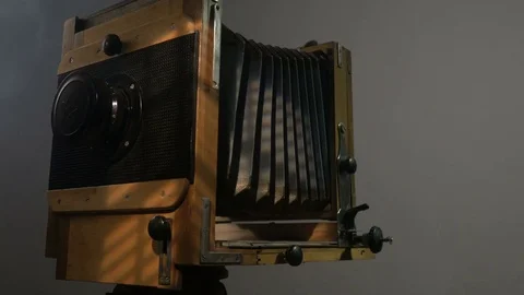 Low angle view of bearded photographer adjusting old vintage wooden photo camera Stock Footage 75923687