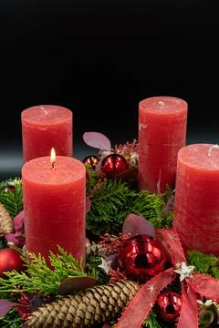 Low angle view of beautiful advent wreath with one burning candle on black ba Stock Photos