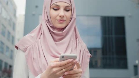 Low angle view of beautiful muslim woman standing near modern office building Stock Footage 156640249
