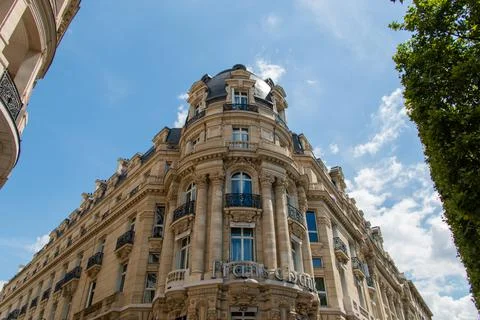 Low angle view of a beautiful old French building under blue sky Stock Photos
