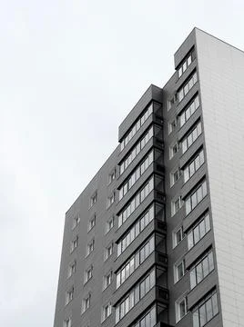 Low angle view from below of new gray multi-storey apartment building that has Stock Photos