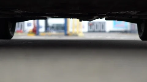 Low angle view between the tyres of a car Stock Footage 94048721