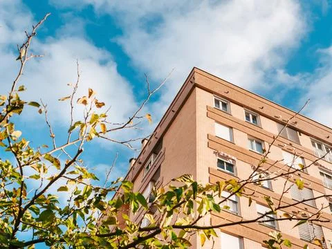 Low angle view on a big brick house with trees in front Stock Photos