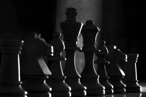 Low angle view black chess pieces, selective focus on the king Stock Photos