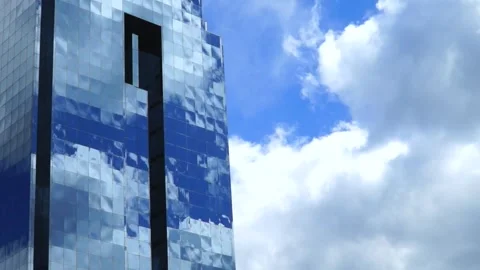 Low Angle View of Blue Glass Skyscraper With Fast Moving Clouds in Warsaw Poland Stock Footage 345992645