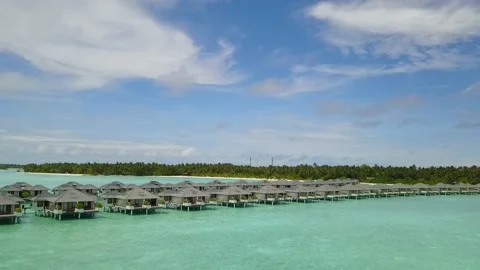 Low angle view of the blue lagoon with bungalow from drone 4K Stock Footage 120693045
