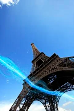 Low angle view of blue streak of lights passing under Eiffel Tower 스톡 사진