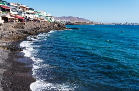 Low angle view of boardwalk and waterfront at Playa Blanca, Lanzarote against Stock Photos
