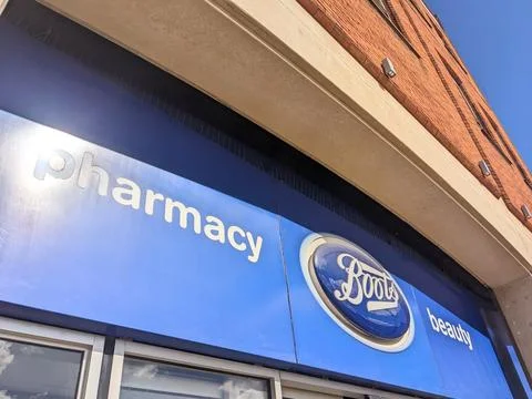 Low angle view of a Boots pharmacy and beauty sign on a modern high street Stock Photos