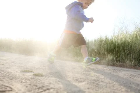 Low angle view of a boy running outdoors Stock Photos