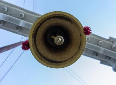 Low Angle View of Brass Temple Bell with Red Tassels against Blue Sky Stock Photos