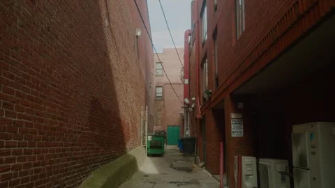 Low angle view of brick building with fire pipe and dumpster in Portsmouth Stock Footage 297237531