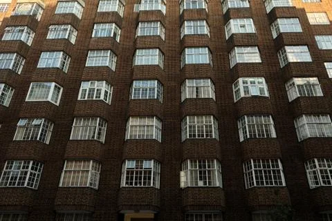 Low angle view of brick wall building facade with windows in London, UK Foto stock