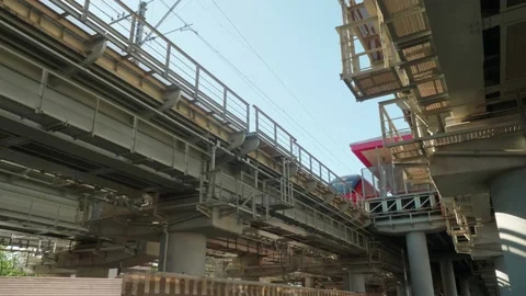 Low angle view of bridge with railways for trains. Train goes from station to Stock Footage 135737202