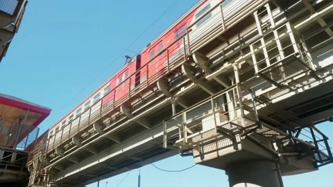 Low angle view of bridge with railways for trains. Train goes from station to Stock Footage 135737730