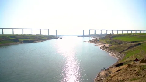 A low-angle view of a bridge under construction, with the sun shining bright Stock Footage 301710457