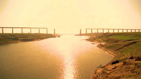 A low-angle view of a bridge under construction, with the sun shining bright Stock Footage 301710484