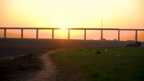 A low-angle view of a bridge under construction, with the sun shining bright Stock Footage 301710493