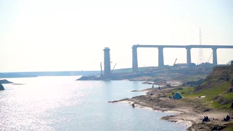 A low-angle view of a bridge under construction, with the sun shining bright Stock Footage 301710495