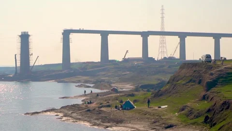 A low-angle view of a bridge under construction, with the sun shining bright Stock Footage 301710498