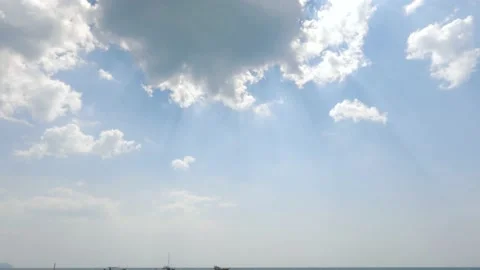 Low Angle View of bright noon sun on soft blue sky with clouds, sun shining o Stock-Footage 166926754