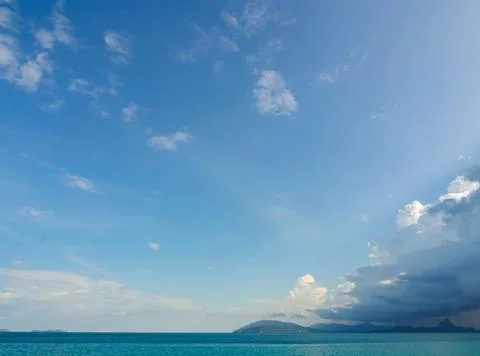 Low Angle View of bright noon sun on soft blue sky with clouds, sun shining o Stock Photos