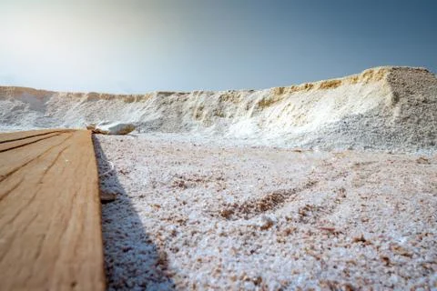 Low angle view of brine salt farm with blue sky. Pile of organic sea salt nea Stock-Fotos