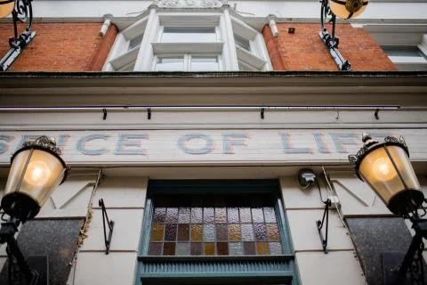 Low Angle View of a British Pub and its Signboard Over the Entrance Stock Photos