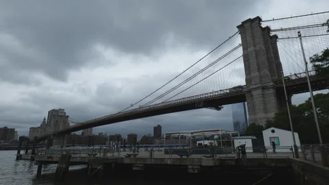 A low angle view of the Brooklyn Bridge under cloudy skies. Stock Footage 310622935
