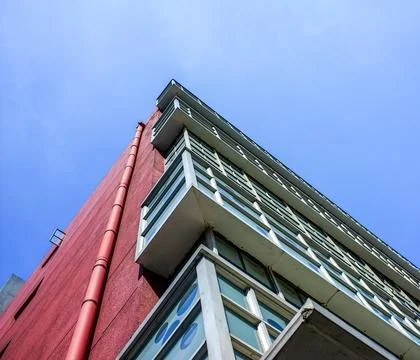 Low angle view of building architectural details against blue sky - Design .. Stock Photos
