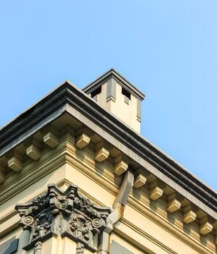 Low angle view of building architectural details against blue sky - Design .. Stock Photos