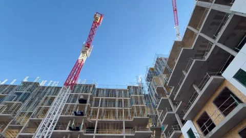 Low angle view of building under construction with cranes Stock Footage 326092486