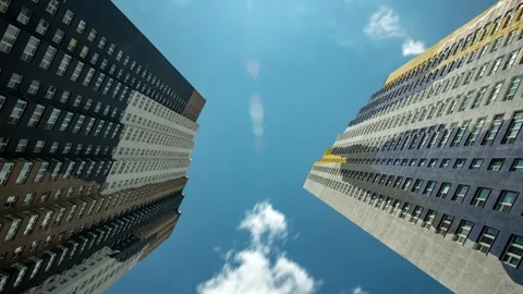 Low Angle View Of Buildings with Clouds In The Blue Sky 4k timelapse 스톡 동영상 274901189