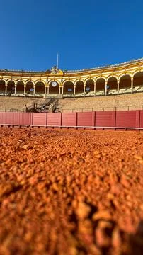 Low-angle view of bullring with red sand and arches Stock Photos