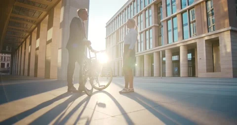 Low angle view of business colleagues chatting outside business center Stock Footage 156448736