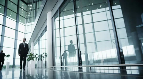 Low angle view of business group walking through large modern office building. Stock Footage
