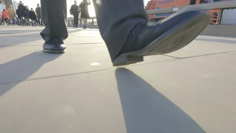 Low angle view of a business man's feet walking Video stock 99208871