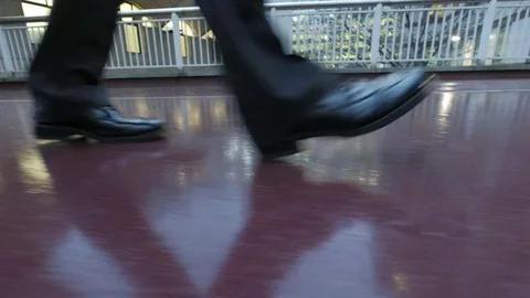 Low angle view of a businessman walking at dusk Stock Footage 84536778