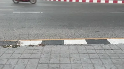Low-angle view of a busy town street with pedestrians and vehicles Stock Footage 311504554