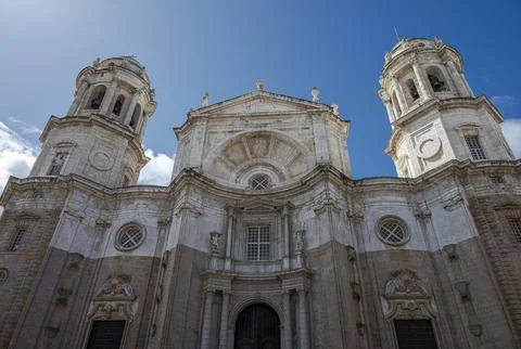 Low-angle view of Cadiz Cathedral facade with both Levante and Poniente tower Stock Photos