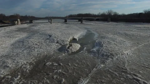 Low angle view of camera moving over ice melting on Maumee River in Ohio Stock Footage 60030663