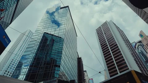 A low-angle view captures the towering modern skyscrapers of Hong Kong's urban Video stock 338311514