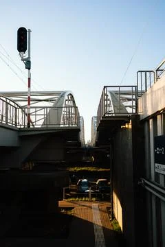 Low angle view capturing railway bridge adorned with red traffic light, while Foto stock