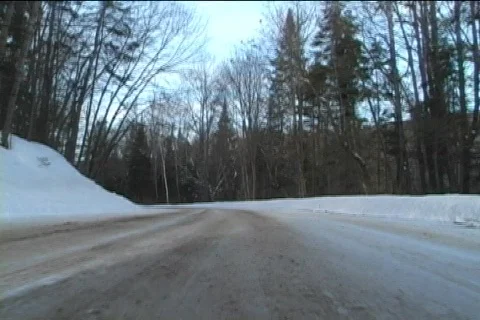 Low angle view of a car driving through remote snowy road Video stock 65628