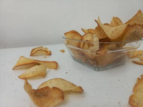 Low Angle View of Cassava Chips Scattered on White Table Stock Photos
