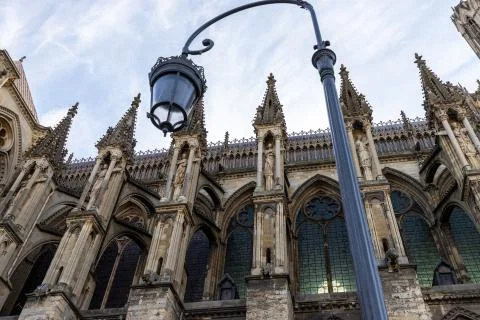 Low angle view at cathedral Notre Dame in Reims with street lamp in foregroun Stock Photos