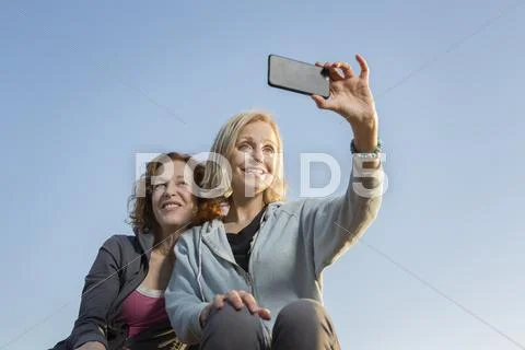Low Angle View Of Caucasian Women Taking Selfie